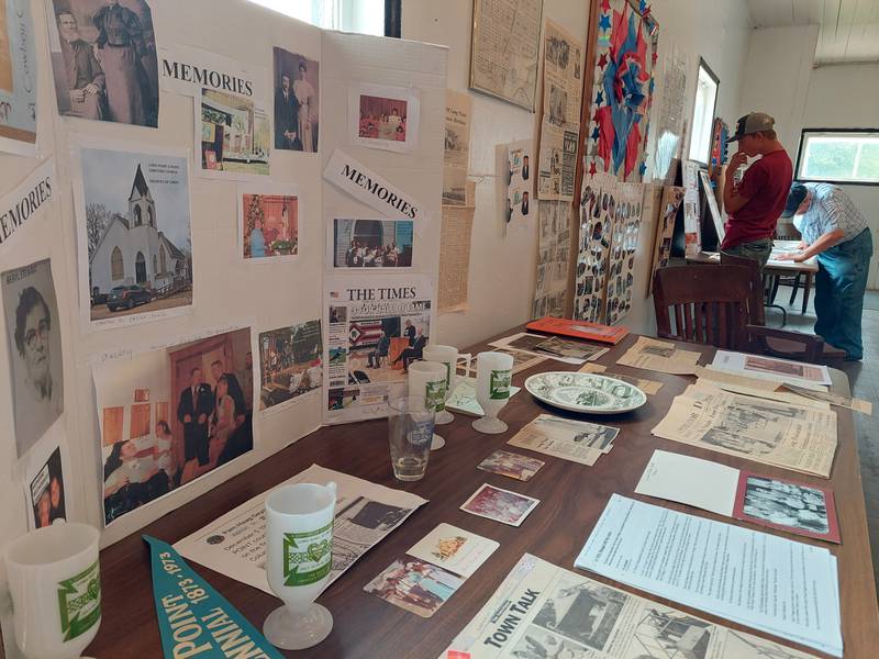 Residents look at history exhibits Sunday, July 16, 2023, at the Village Hall during Long Point's Sesquicentennial celebration.