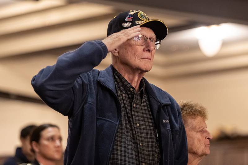 Army veteran Rodney Bjerke salutes as the National Anthem is played during the Veterans Day Assembly at Joliet Central High School on Nov. 7, 2025.