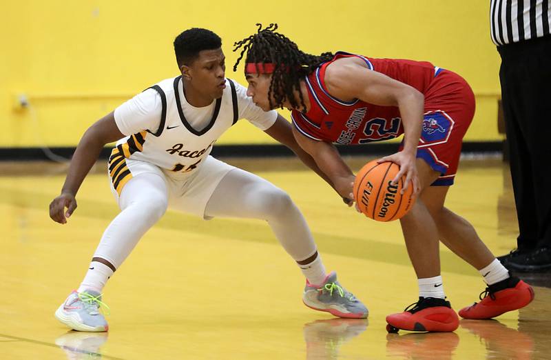 Dundee-Crown's Anthony Spain looks to drive on Jacobs' Chris Williams during a Fox Valley Conference boys basketball game on Tuesday, February. 3, 2026, at Jacobs High School in Algonquin.