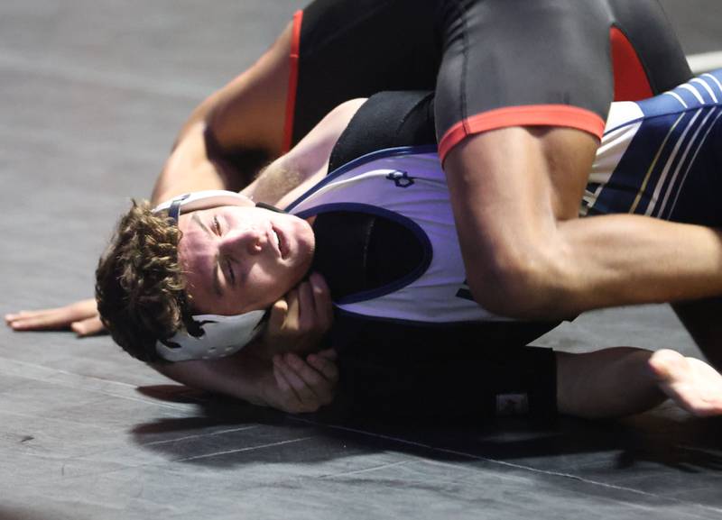 Marquette's Baeu Thompson wrestles Bradley-Bourbonnias's Jayden Cooper on Wednesday, Jan. 14, 2026 in Bader Gymnasium at Marquette Academy.