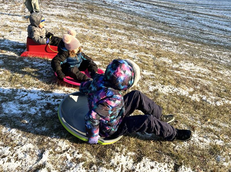 Eliana, Amari, and Josiah Orellana, ages 11, 5, and 3 of Naples, Florida, head down the hill at Winter Park in Morrison on Friday, Jan. 3, 2025. The Orellana family was visiting relatives in Morrison and wanted to try sledding following the dusting of snow that fell across the region.