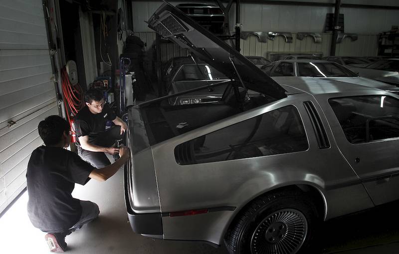 Technicians Alejandro Sosa of Crystal Lake, left, and Jonathan Valadez, of Cary, work on a DeLorean car at DeLorean Motor Company – Midwest in Crystal Lake.