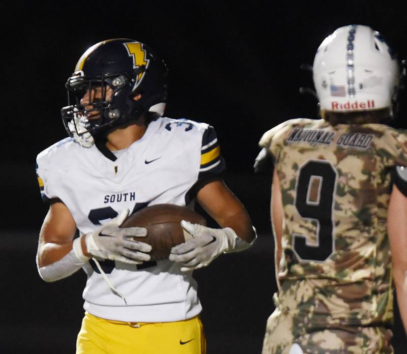 Joe Lewnard/jlewnard@dailyherald.com
Glenbrook South's Nate Canning has the ball after scoring a second-quarter touchdown during Thursday’s game at Prospect.