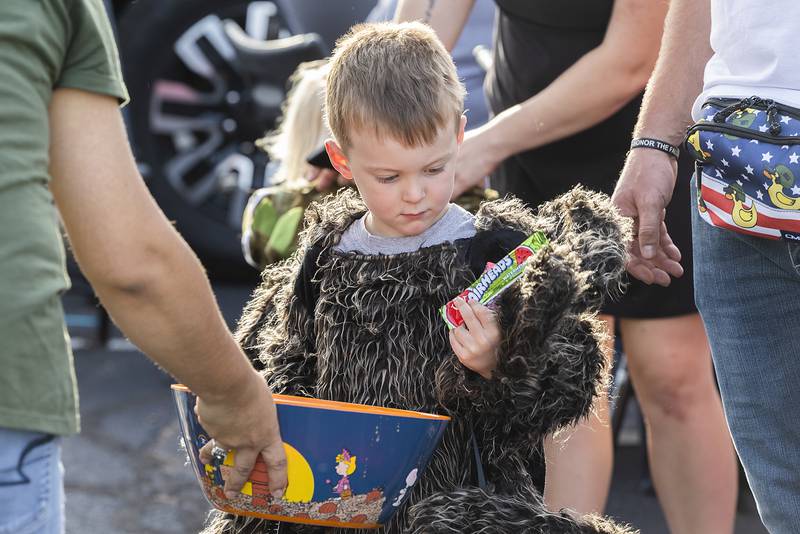 Spider-boy Waylon Coutts, 4, used one of his eight arms to dig into a bowl of candy Tuesday, Oct. 29, 2024, in Sterling. The Sterling Police Department held their annual trunk or treat in the department’s parking lot on Tuesday. Hundreds of kids and parents attended the event.