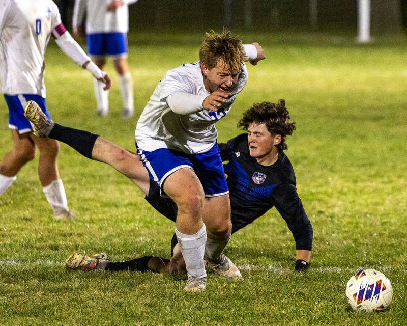 Gavin Pickert (23) of Hinckley-Big Rock jumps over Landon Johnson (20) of Somonauk/Leland/Newark to pursue ball in the Little Ten Conference Championship match on Thursday, Oct. 9, 2025 at Hinckley-Big Rock School in Hinckley.