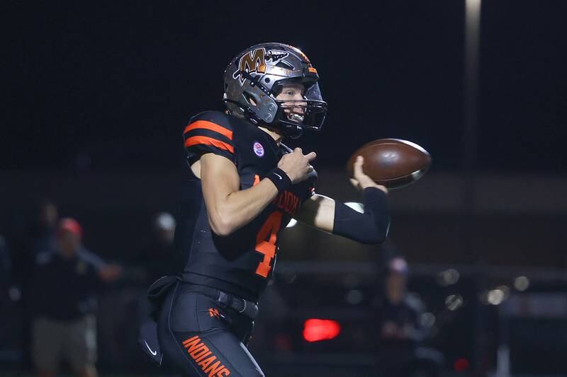 Minooka’s Zane Caves side arms a pass against Lincoln-Way East on Friday, Nov. 8, 2024 in Minooka.