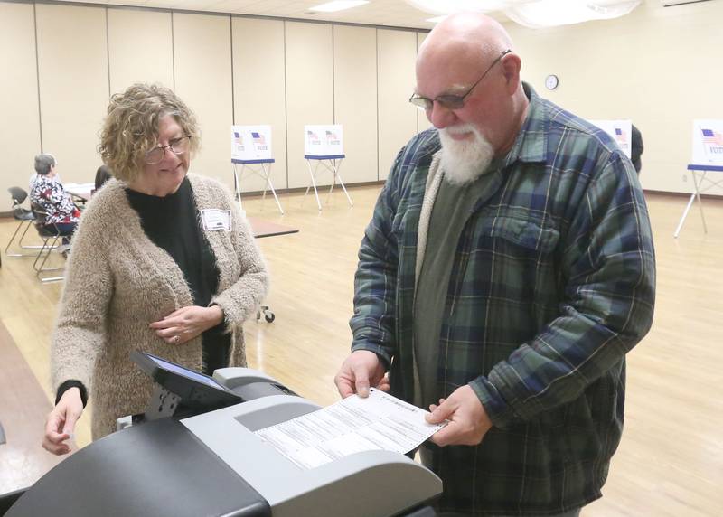 Election judge Leandra Harris helps John Donofrio cast his ballot on Tuesday, March 17, 2026 at the Bureau County Metro Center in Princeton.