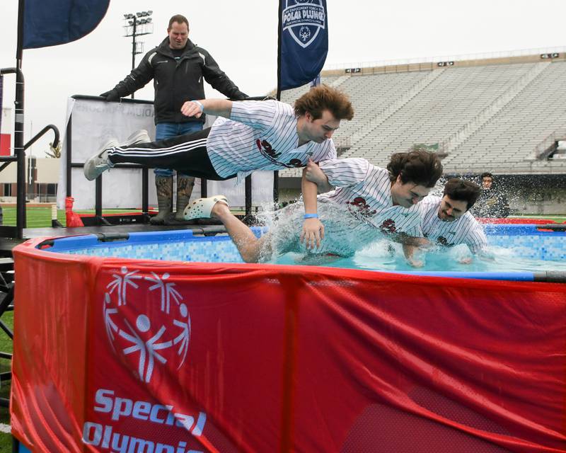Members of the Phi Kappa Psi fraternity at NIU bellyflop into the pool during the Polar Plunge event held at Huskie Stadium in DeKalb.