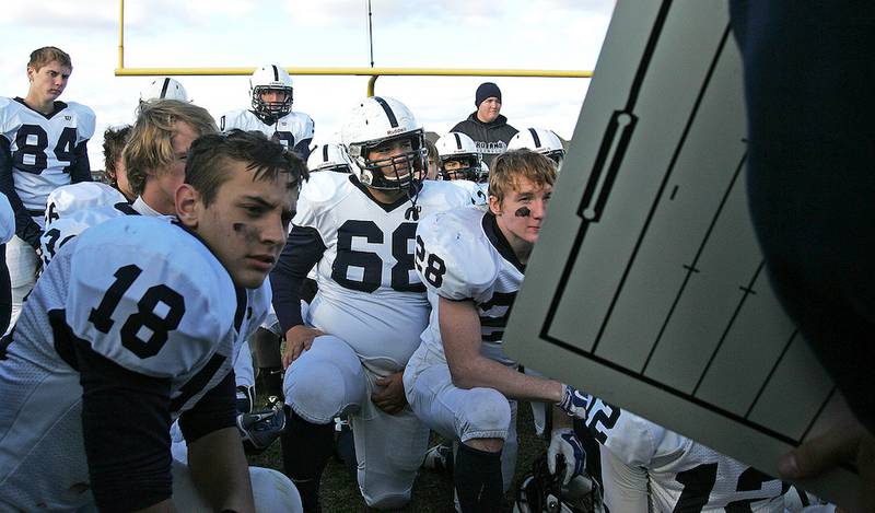 Cary-Grove players including Jake Clemment (84) Erik Norberg (18), Zachary Cohen (68) and Kyle Preeeley (28) listen at halftime as the coaching staff discusses the first half of play. Cary-Grove beat St. Charles North 35-14 to advance to the third round of the class 7A state playoffs on Saturday, Nov. 8, 2014.