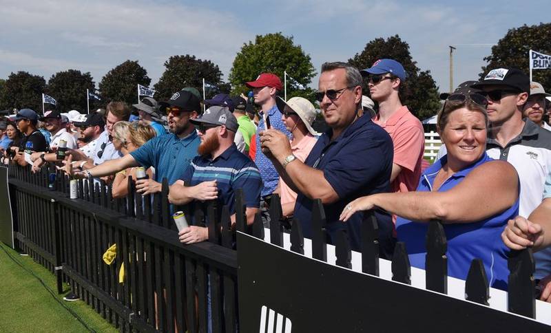 Fans watch players on the driving range prior to the start of the LIV Golf Invitational Chicago 2022 in Sugar Grove on Saturday.