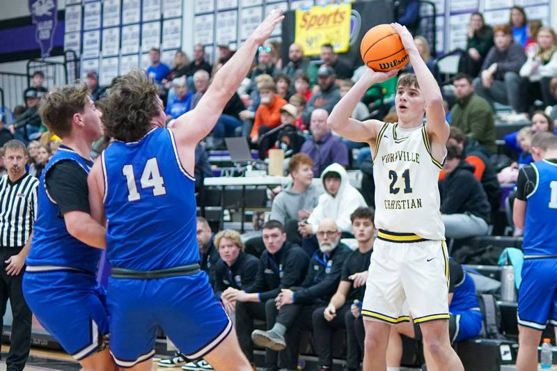 Yorkville Christian's Jordan Purvis (21) shoots a three pointer against Hinckley-Big Rock's Martin Ledbetter (14) during a basketball game in the opening round of the 61st annual Plano Christmas Classic at Plano High School on Monday, December 23, 2024.