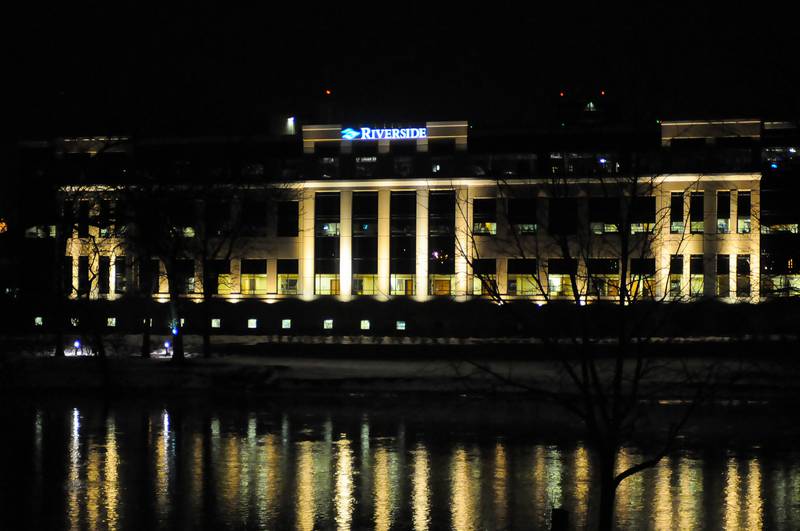 Lights illuminating Riverside Medical Center in Kankakee reflect on the Kankakee River.