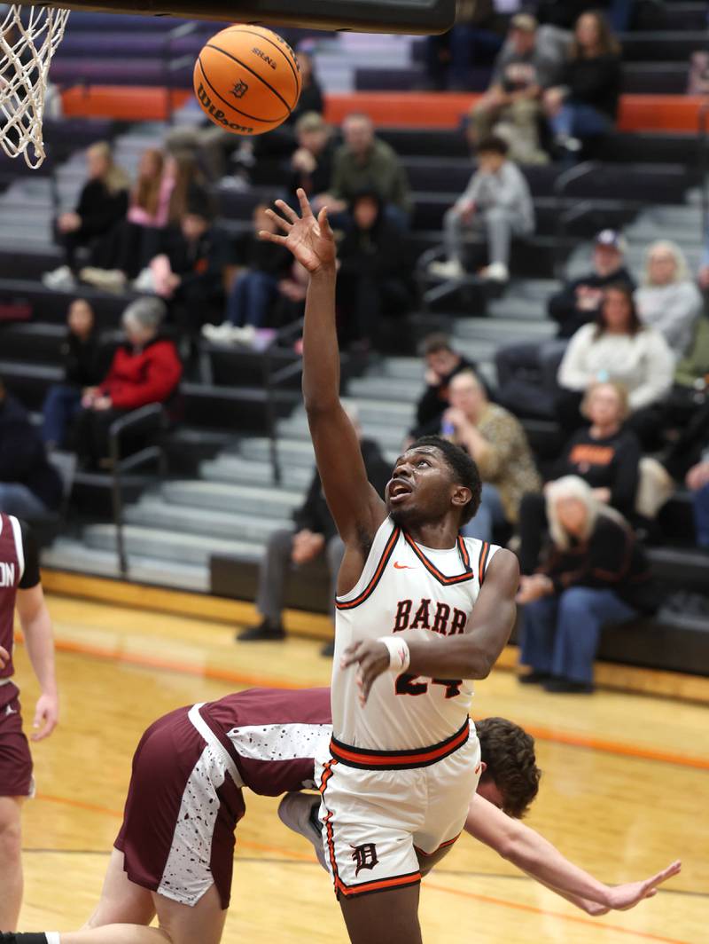DeKalb's Myles Newman gets up a shot in front of a Wheaton Academy defender during their game Wednesday, Jan. 14, 2026, at DeKalb High School.