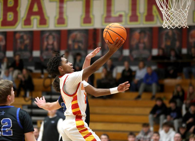 Batavia’s Xavier Justice gets a shot up during a game against St. Charles North on Wednesday, Dec. 11, 2024 in Batavia.
