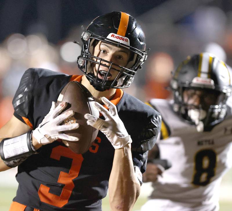 DeKalb's Ethan Tierney hauls in a touchdown pass in front of Metea Valley's Daniel Pere during their game Friday, Sept. 16, 2022, at DeKalb High School.
