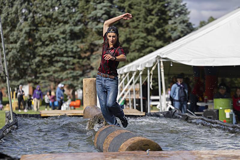 Brett Wells eyes the finish during the boom run at the Lumberjack show Saturday, Oct. 7, 2023. Competitors try to make it across and back on the floating logs in 9 seconds.
