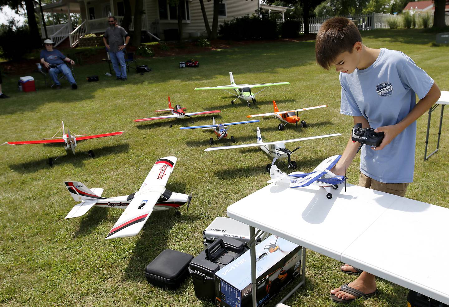 Charlie Missak, 12, performs pre-flight checks on his radio-controlled plane on Thursday, Aug. 8, 2024, while flying planes with other members of the Chain-O-Lakes Eagles R/C Club near Hebron.
