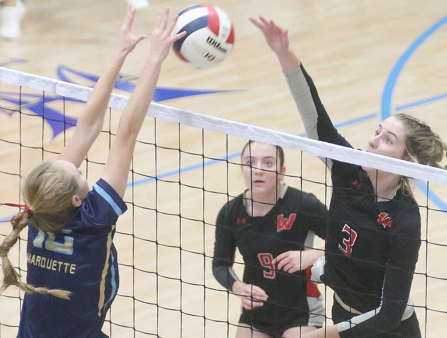 Marquette's Lilly Craig blocks a spike from Woodland's Malayna Pitte on Thursday, Oct. 19, 2023 at Bader Gym.