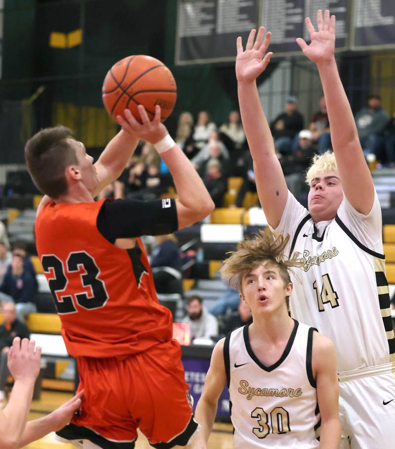 Sycamore's Xander Lewis and Michael Chami defend the shot of Sandwich's Chance Lange during their game Friday, Nov. 24, 2023, in the Leland G. Strombom Holiday Tournament at Sycamore High School.