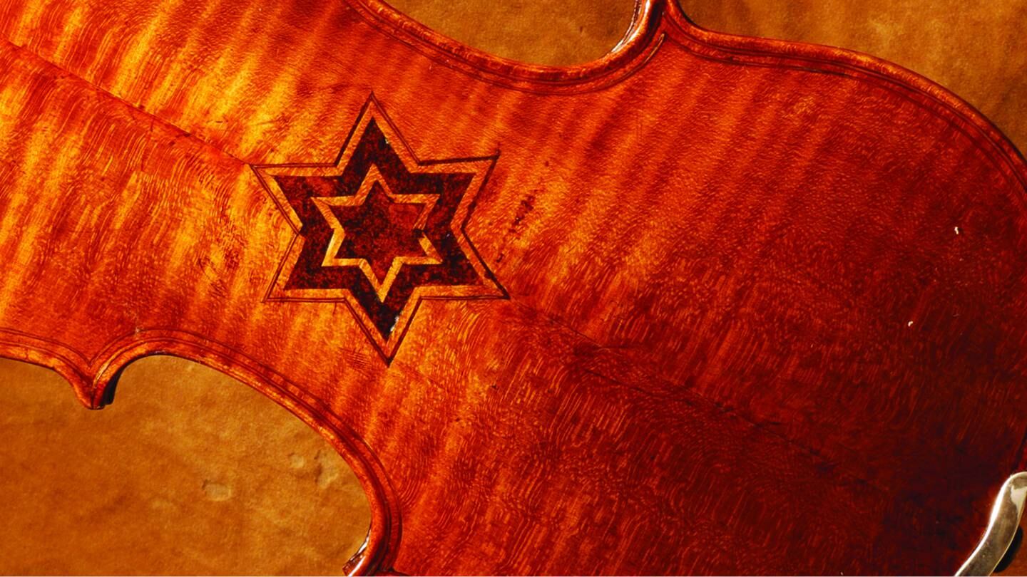 The Violins of Hope, Holocaust-era violins and other stringed instruments, are the private collection of Israeli violin makers Amnon and Avshalom (Avshi) Weinstein.  Some like this one feature  the Star of David on the back.