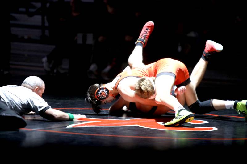 St. Charles East’s Anthony Gutierrez (top) wrestles Batavia’s Colin Peyton in the 165-pound weight class during a dual meet in St. Charles on Thursday, Jan. 4, 2024.