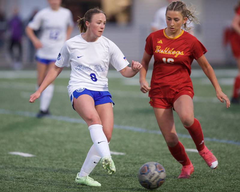 St. Charles North's Kelly Keira kicks the ball against Batavia's Olivia Patrick on Thursday, April 17,2025 in Batavia.