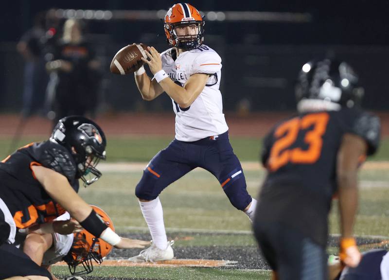 Naperville North's Carson Marlar has time to look for a receiver in the DeKalb secondary during their game Friday, Sept. 22, 2023, at DeKalb High School.