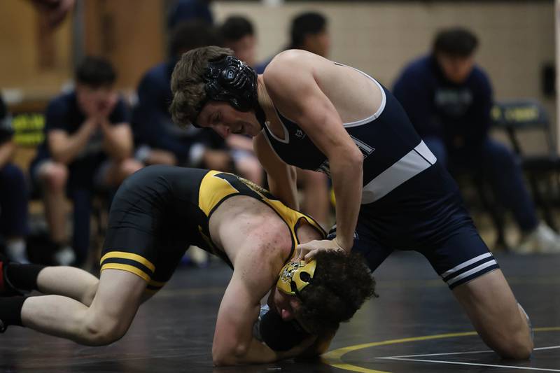 Plainfield South’s Nathan Cameron works over Joliet West’s Malakai Lancaster-Williams in the 132 pound match on Wednesday, Dec. 3, 2025 in Joliet.