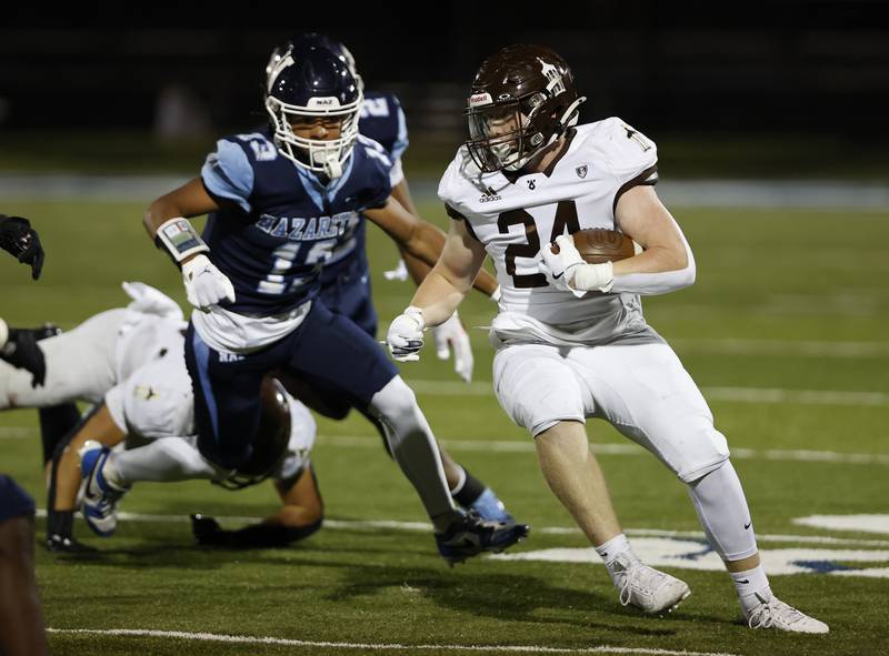 Joliet Catholic's Lawrence Stringham (24) runs the ball during the varsity football game between Joliet Catholic and Nazareth academies on Friday, Sep. 27, 2024 in La Grange Park.