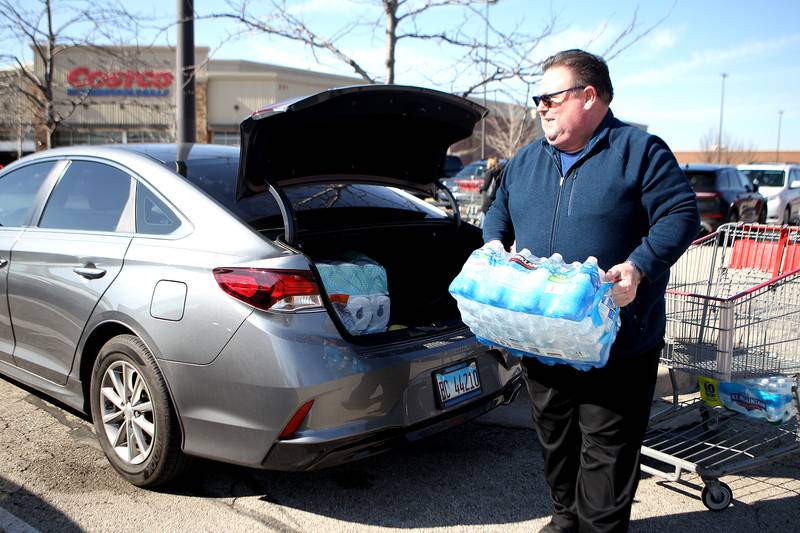 Matt Beres of St. Charles loads his car with bottles of water and the last rolls of toilet paper found at Costco in St. Charles in response to the Covid-19 pandemic. The first case in Kane County was announced on March 10.The Hollister store in Geneva Commons has closed.