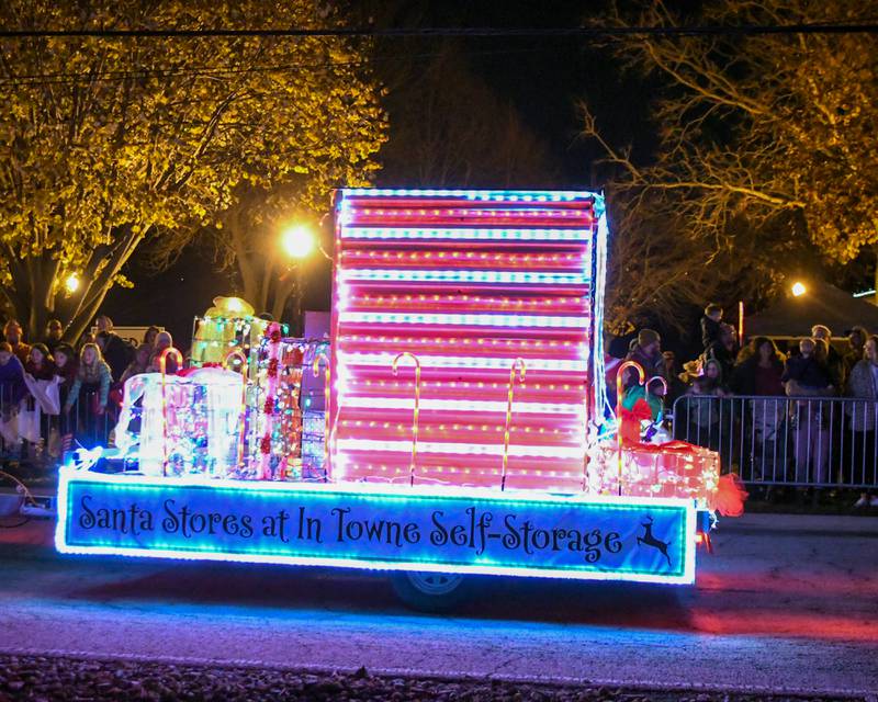 A Christmas float for self-storage passes by in the parade on Friday Nov. 21, 2025, before the tree lighting ceremony held at Riverfront Park in Yorkville.