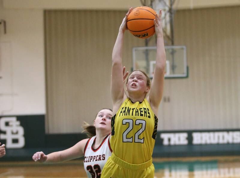 Putnam County's Kacie Coleman grabs a rebound over Amboy/Ohio's Emily Sachs during the Class 1A Regional semifinal game on Tuesday, Feb. 18, 2025 at St. Bede Academy.