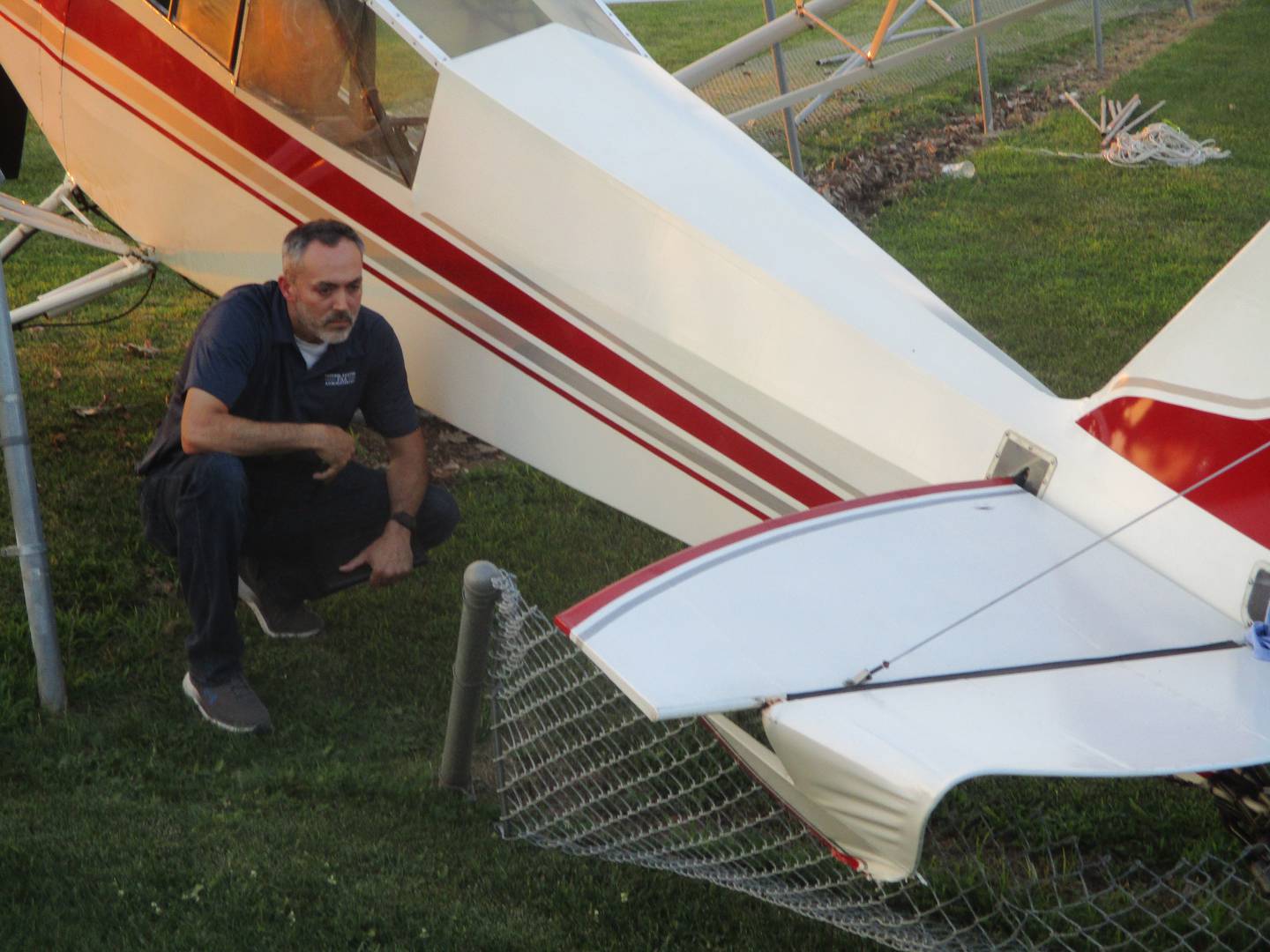 Beau Klingbeil, aviation safety inspector with the Federal Aviation Administration, examines the airplane that made an emergency landing in Joliet on Thursday. Aug. 14, 2025