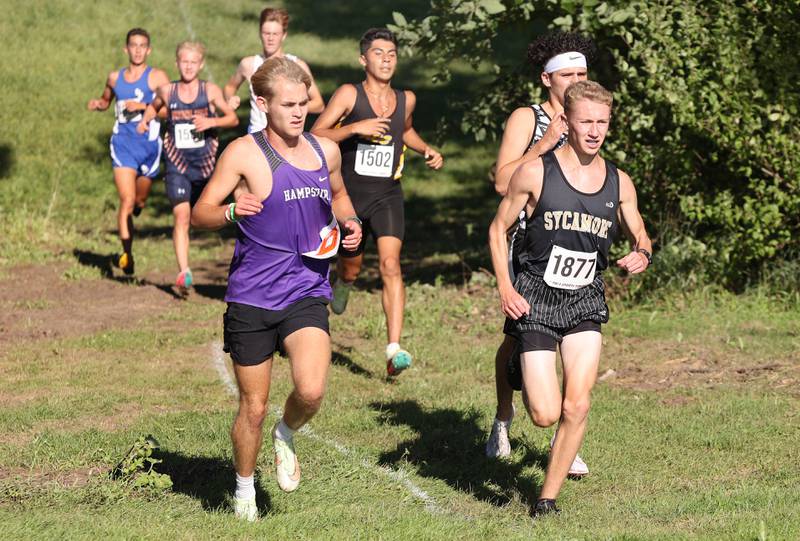 Sycamore's Ethan Solfisburg leads a group around a turn Tuesday, Aug. 30, 2022, during the Sycamore Cross Country Invitational at Kishwaukee College in Malta.