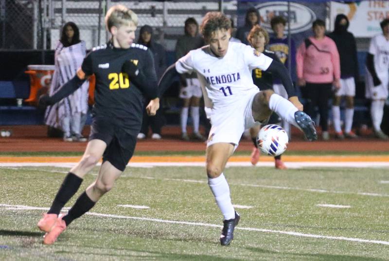 Mendota's Cesar Casas puts a block on the ball as Normal U-High's Keaton Ash defends during the Class 1A State semifinal game on Thursday, Nov. 7, 2024 at Hoffman Estates High School.