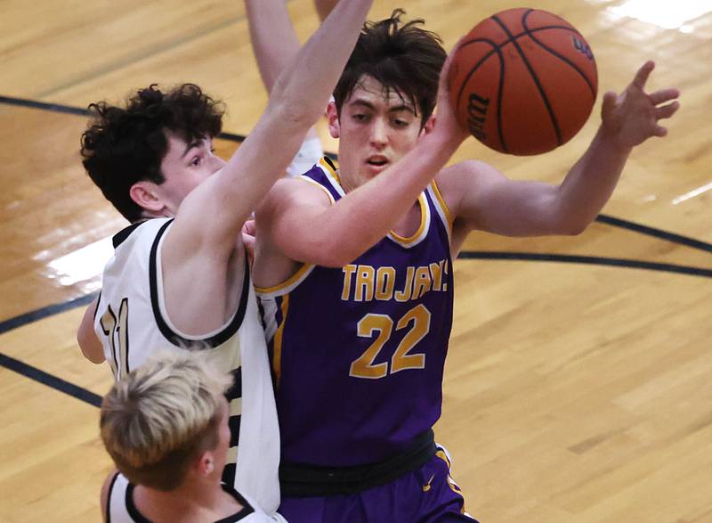 Mendota’s Aden Tillman passes the ball out of a Sycamore double-team during their game Wednesday, Dec. 13, 2023, at Sycamore High School.