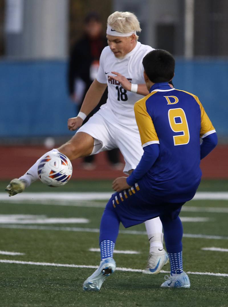 Prairie Ridge's Gabriel Porter kicks the ball away from Chicago De La Salle's Fidel Orozco during an IHSA Class 2A state semifinal soccer match on Friday, Nov. 8, 2024, at Hoffman Estates High School.