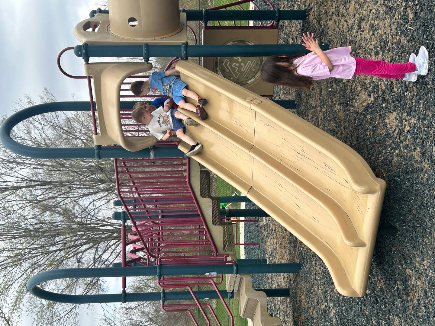 Children play on a slide Tuesday, April 14, at The Early Years Academy in Morrison.