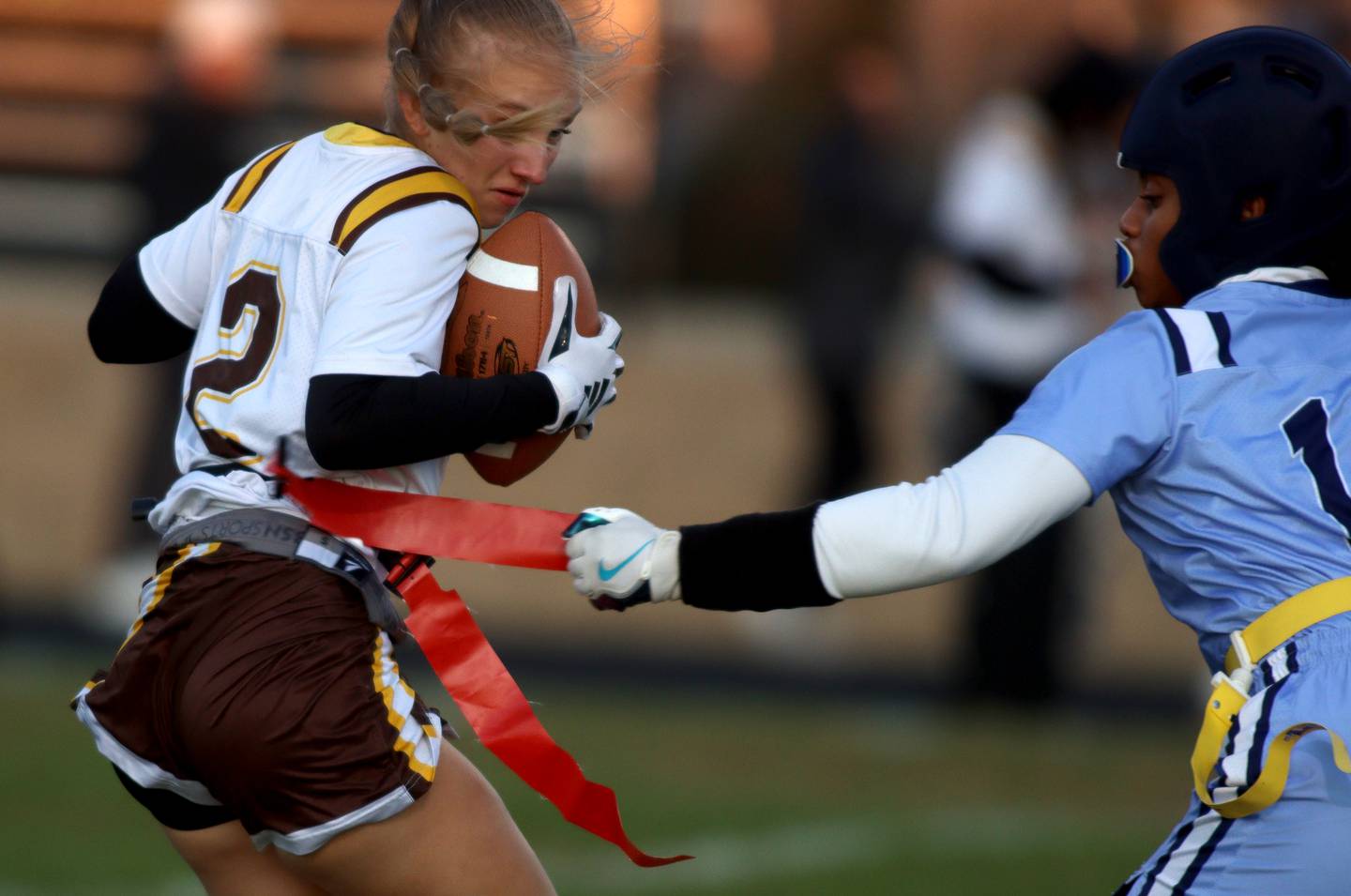 Jacobs’ Dusia Panek, left, tries to get past Rockford Guilford’s Natalyia Stallings in varsity flag football sectional action at Dan Horne Field on the campus of Harvard High School in Harvard  on Tuesday, Oct. 15, 2024.