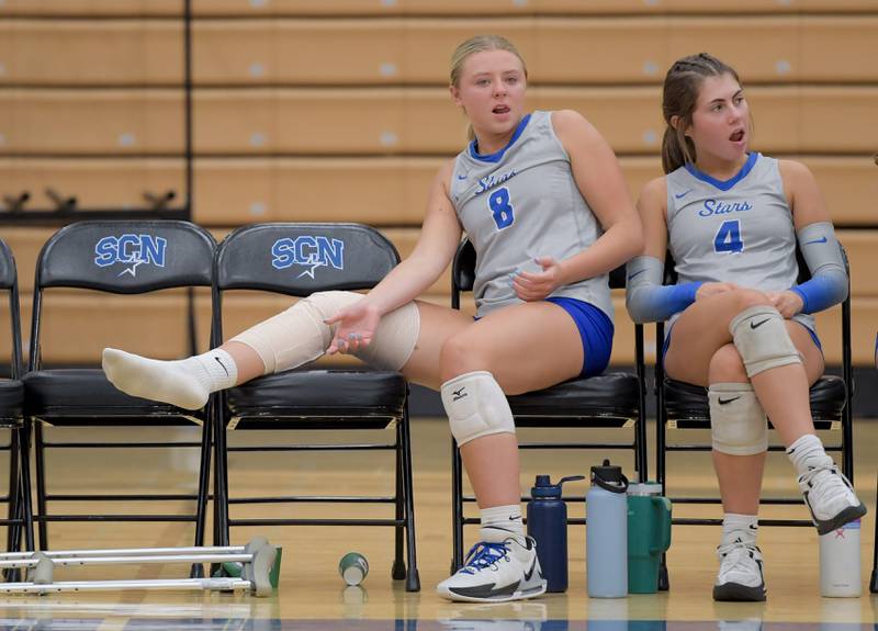 St. Charles North's Adrianna Huptych (8) sits on the bench with her knee wrapped after getting injured during warms before a match against Benet on Wednesday, September 20, 2023.