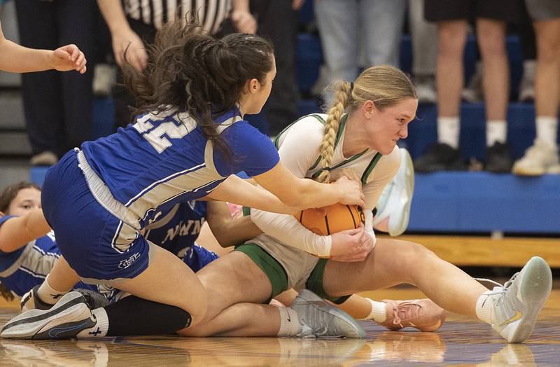 Newman’s Anna Propheter and Wethersfield’s Abbey Carman battle for a loose ball Thursday, Feb. 26, 2026, in the Class 1A sectional semifinal at Eastland.