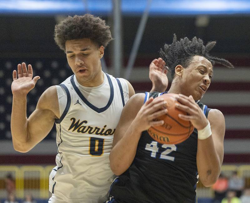 Quincy’s Keshaun Thomas secures a rebound against Sterling’s Andre Klaver Friday, Jan. 26, 2024 at Sterling High School.