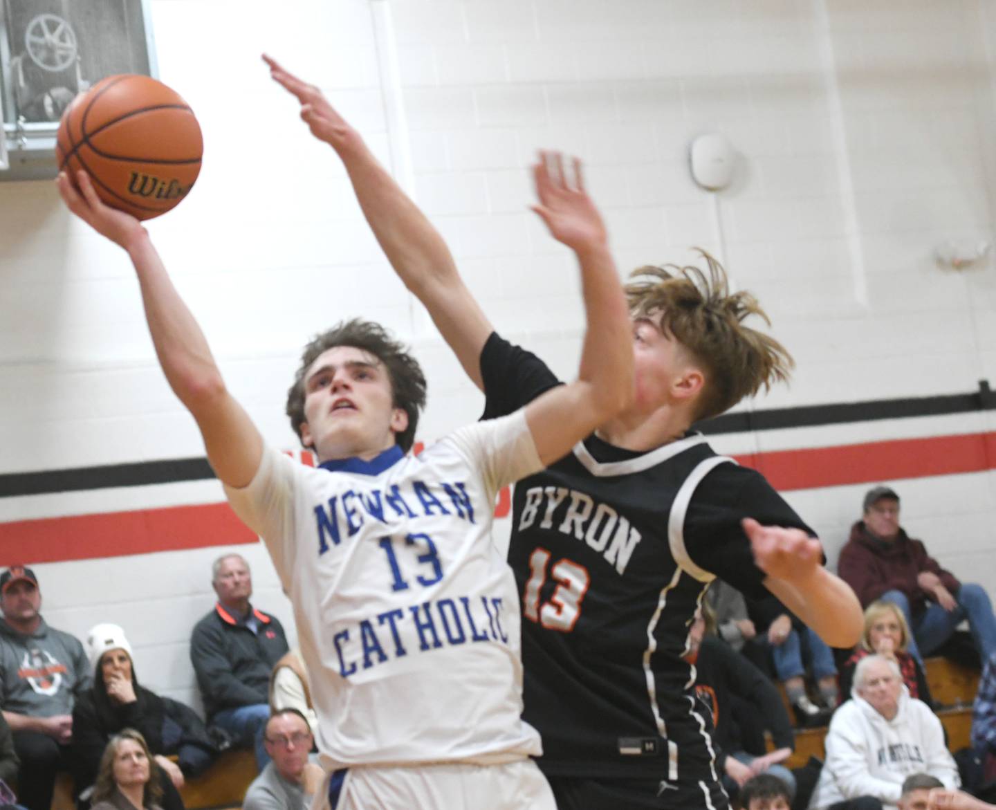 Newman's Nolan Britt avoids a block by Byron's Jack Hiveley at the Forreston Holiday Tournament on Monday night.