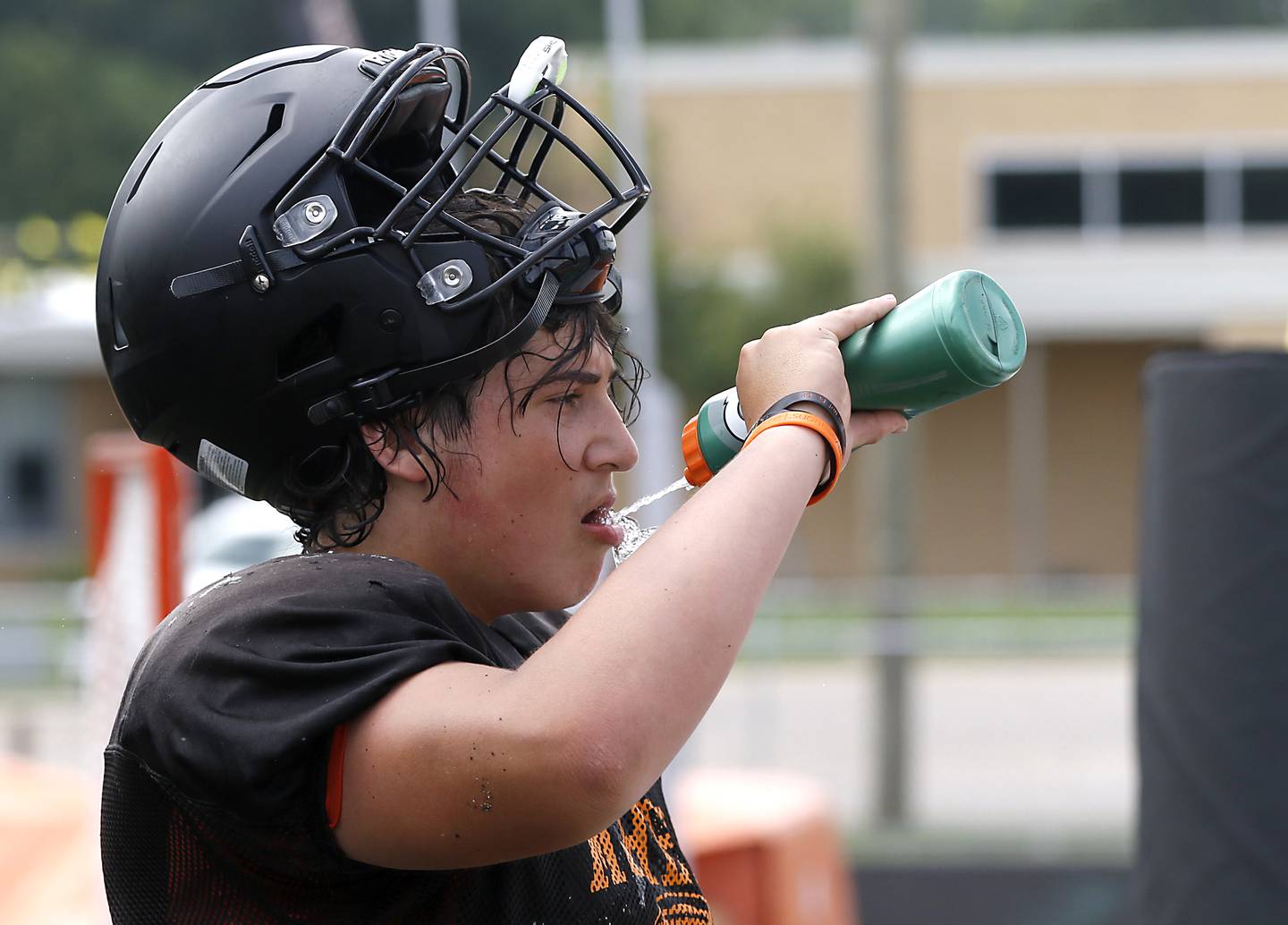 McHenry’s Aiden Ramirez practices gets a drinks of water during football practice on Thursday, July 24, 2025, at McCracken Field, in McHenry.