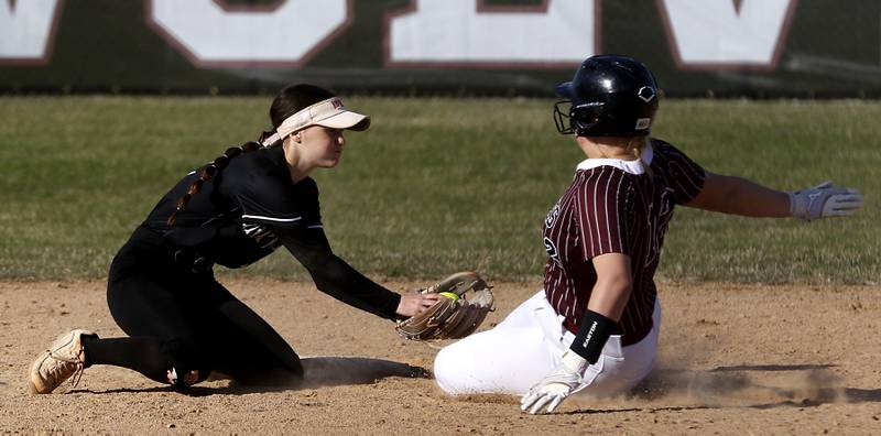 Huntley's Aubrina Adamik tags out Prairie Ridge's Bella Moore at second base during Fox Valley Conference softball game on Monday, April 14, 2025, at Prairie Ridge High School in Crystal Lake.