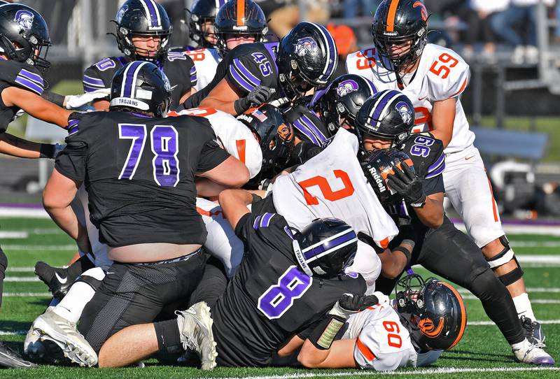 The Downers Grove North defense gang tackles Lincoln-Way West running back Jahan Abubakar during a Class 7A quarterfinal game on November 15, 2025 at Downers Grove North High School in Downers Grove .