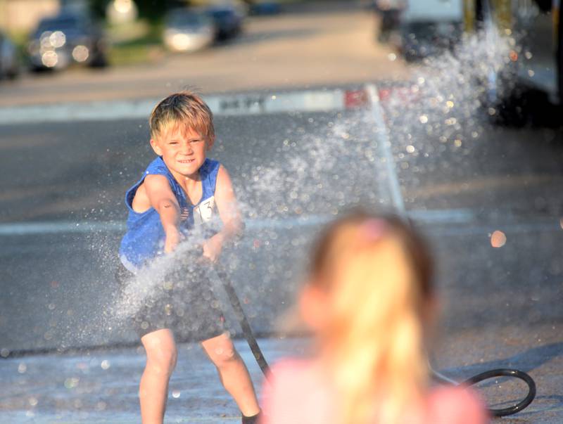 Luxton Warner, 7, of Mt. Morris competes in the kids' water fight at Let Freedom Ring on Monday. The event was organized by the Mt. Morris Fire Department.