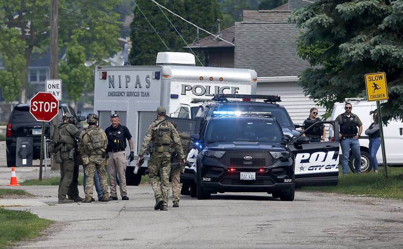 Law enforcement from area departments surround a home on Thursday, June 5, 2025, in the area of Venice Avenue and Court Street in McHenry.