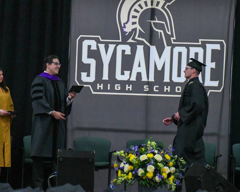 Sycamore High School senior Royce Grados walks across the stage to receive his diploma on Sunday, May 25, 2025, during the Class of 2025 Commencement ceremony at the high school.
