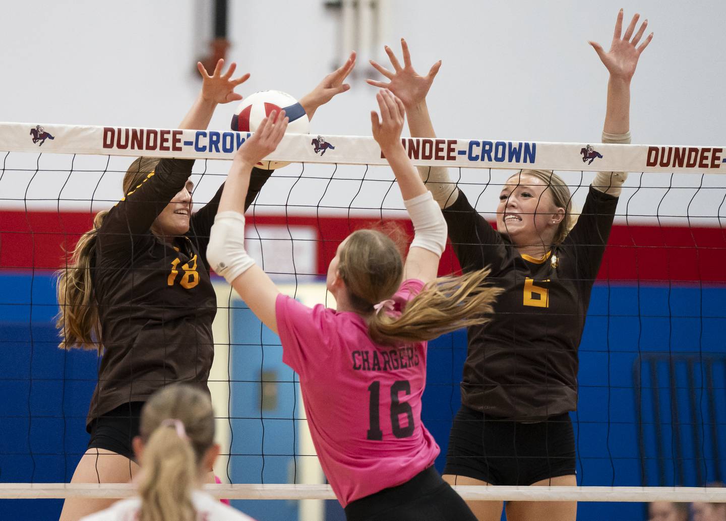 Jacobs' Gracyn Sanders, left, and Rachelle Zieba battle at the net with Dundee-Crown's Victoria Brents during their game on Thursday, October 16, 2025 at Dundee-Crown High School in Carpentersville. Ryan Rayburn for Shaw Local